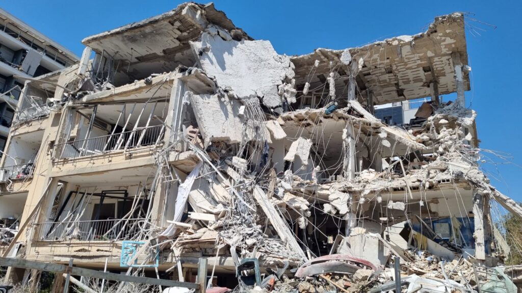 Emergency responders helping injured civilians after Iranian missile strike in Israel urban area