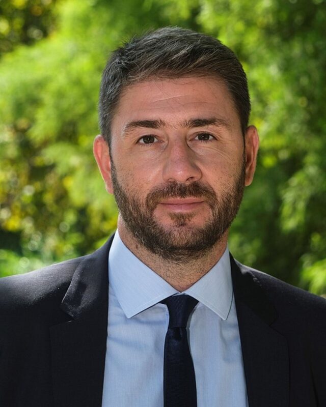 Greek politician Nikos Androulakis speaking at press conference microphones serious expression