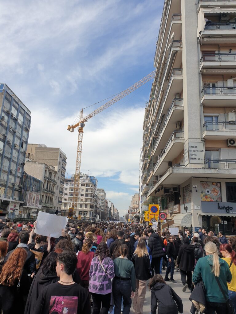 Crowd and media outside Greek courthouse during Tempi train crash trial