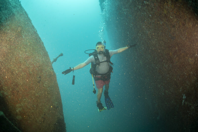 Rescue divers preparing near coastal cave in Vouliagmeni Greece during search operation