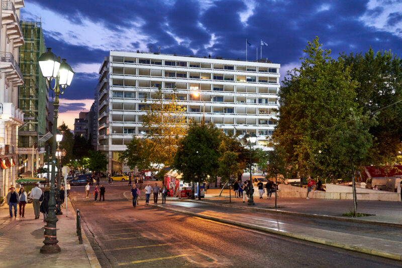 Greek government employee managing digital property registry system on computer